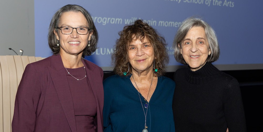 Dean Carol Becker stands with two women.