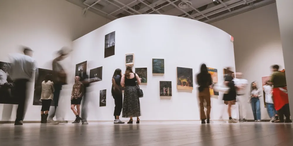 people attend an art exhibition