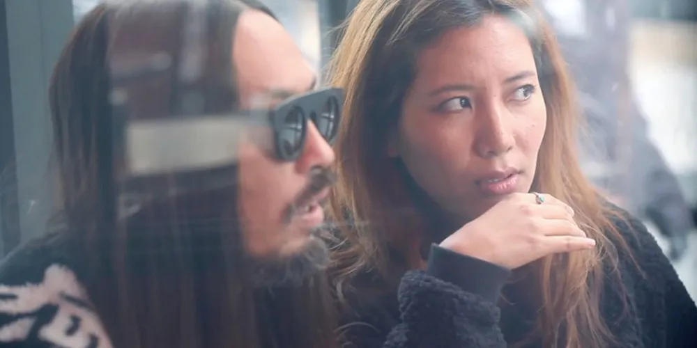 still from Royal Cafe directed Tenzin Dazel of man and woman looking through window