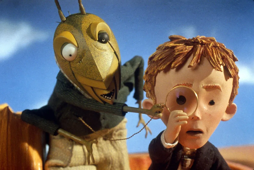 grasshopper and boy looking through a moncole