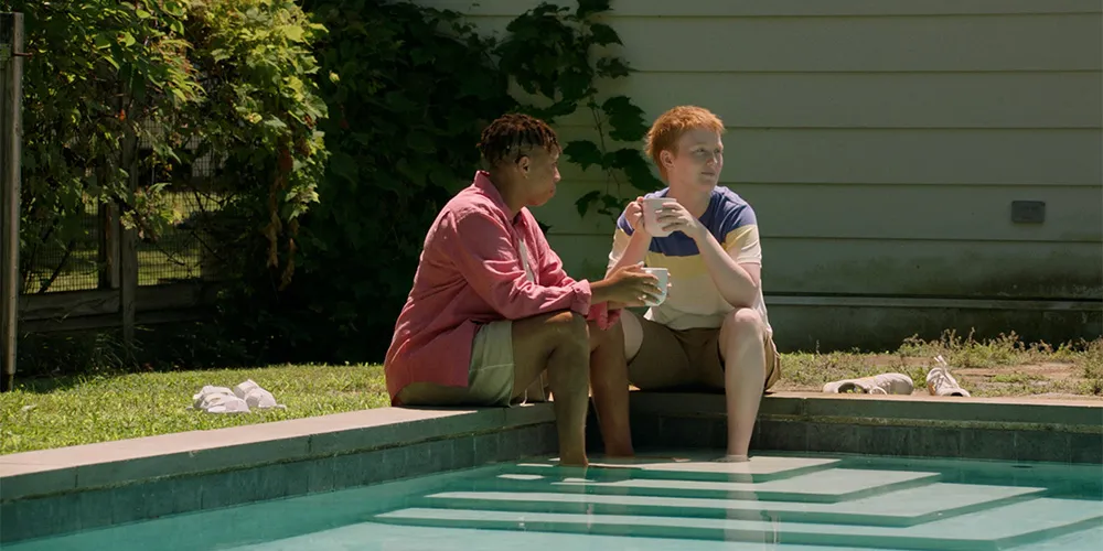 2 teenagers sitting in pool