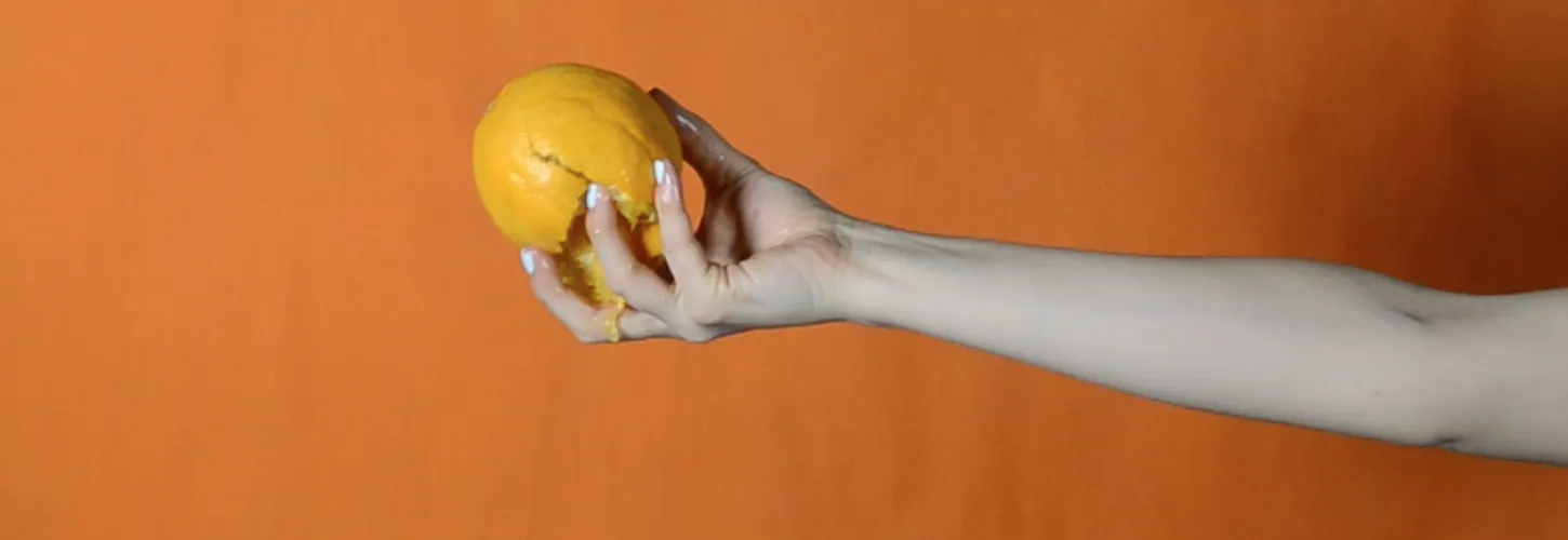 Hand holding an orange