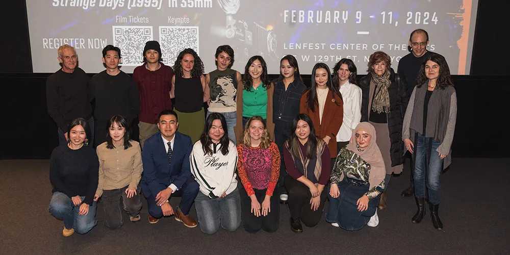 a group of students pose together at the front of a screening room