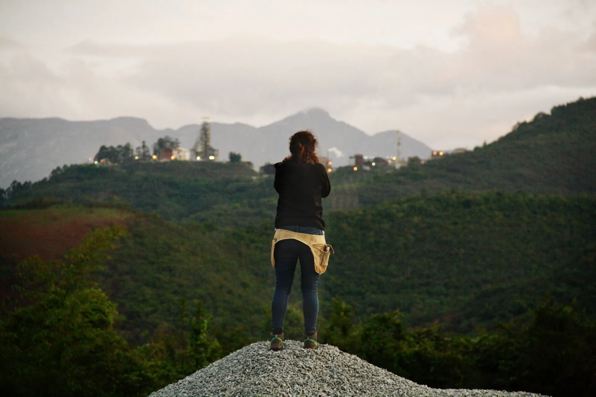 Woman stands on mountain top
