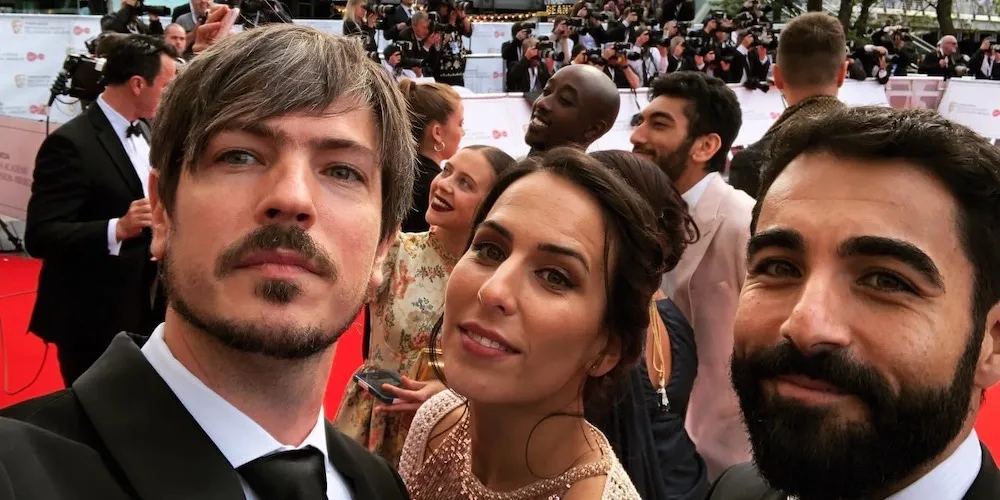 Selfie of two men and one woman