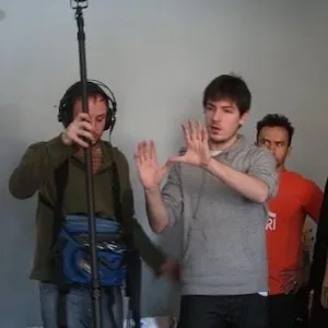 A man directs people with camera equipment