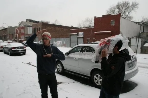 two men stand in the snow