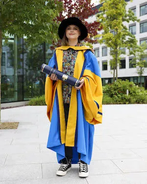 Dr. Orla Tinsley '20 poses with their doctorate 