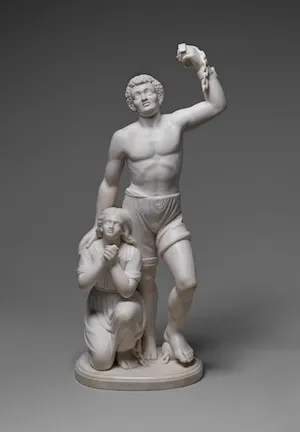 Sculpture of a Black figure holding broken shackles aloft