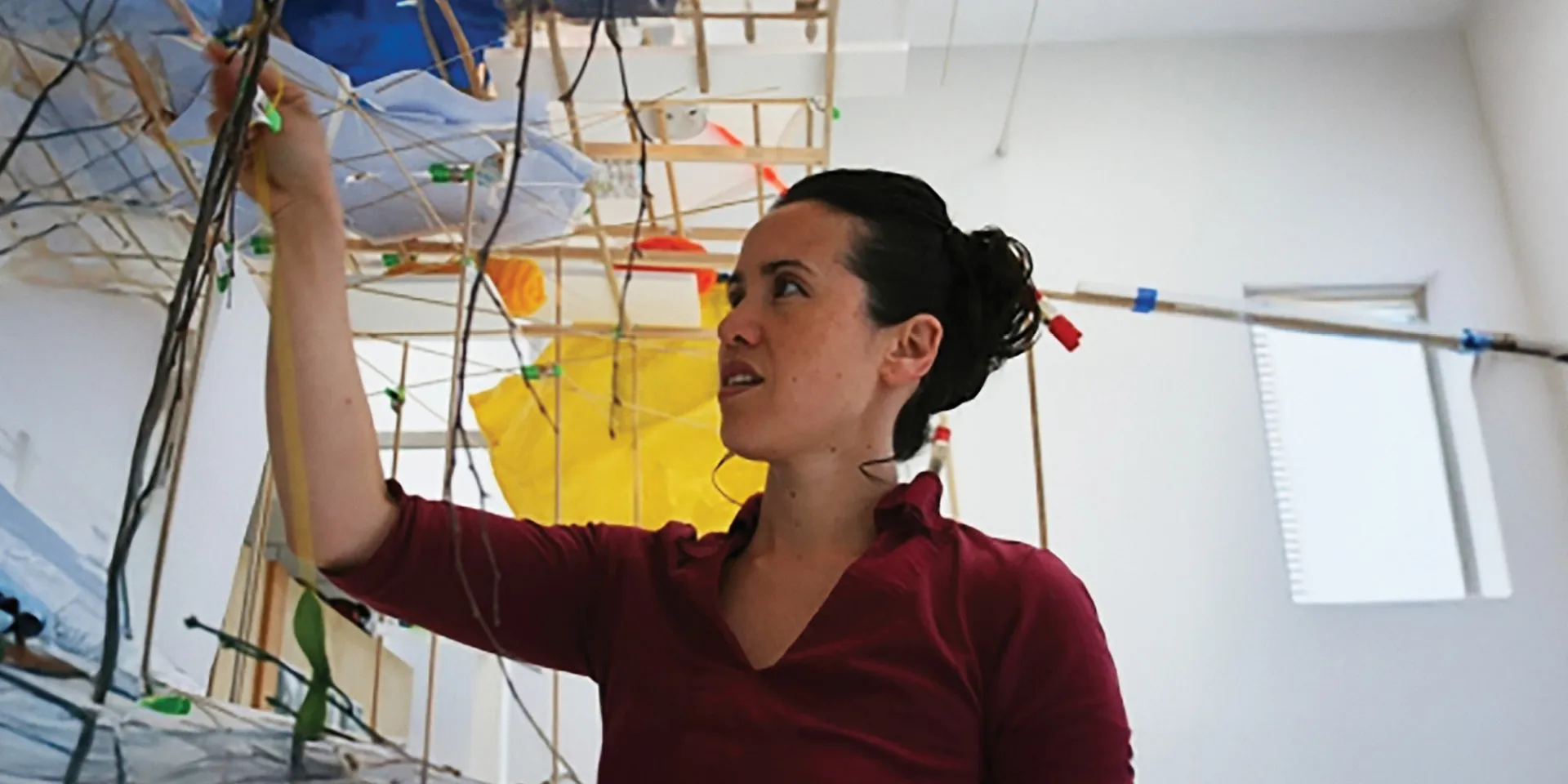 A woman working on a visual arts installation