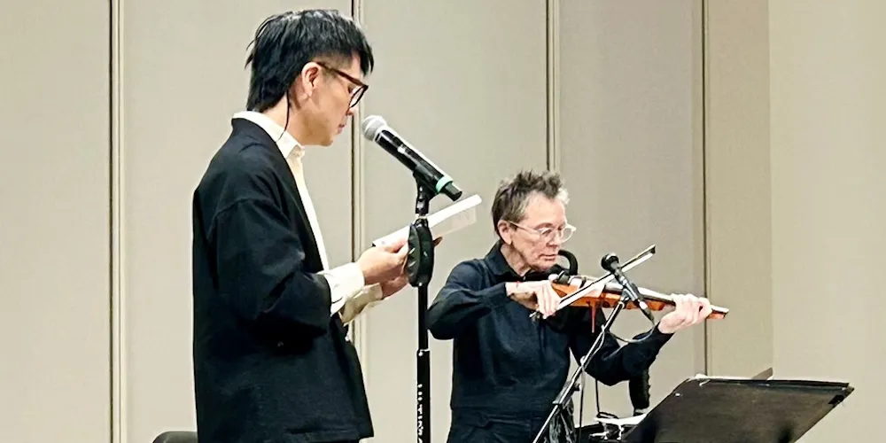 two artists perform on stage