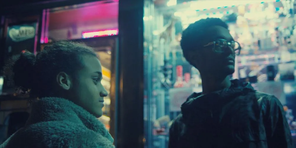 Two young people outside a storefront 