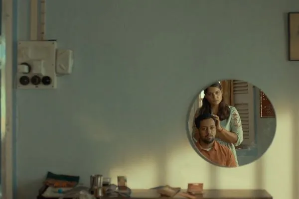 Two people viewed in mirror