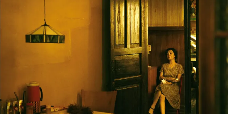 Woman in dress seated in empty room