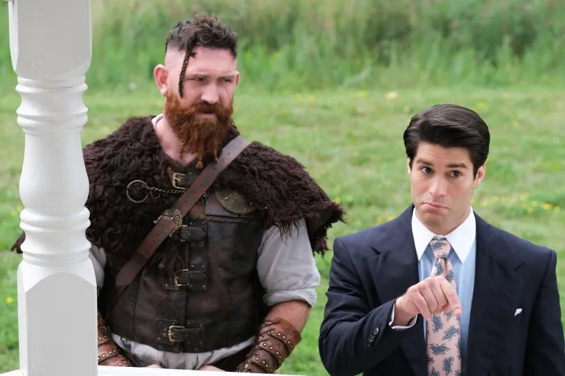Left to right: man in medieval clothing, man in business suit