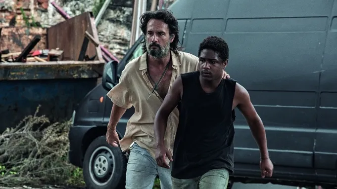 two characters walking in front of black van