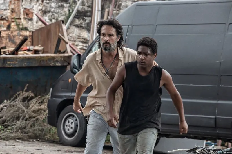 Two men walking away from a black van