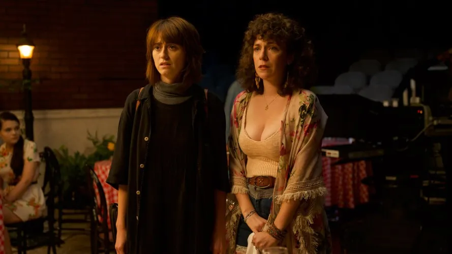 Two woman standing side by side.