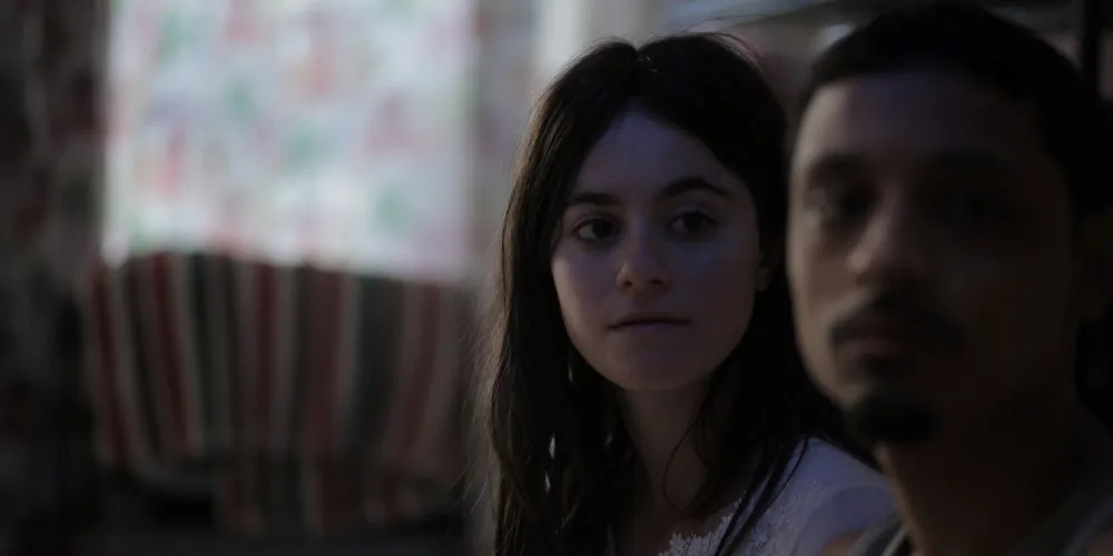 A young teenager looks at a man.