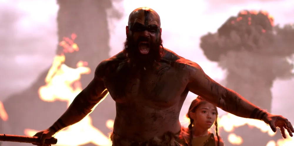 Yelling man in front of a girl and two exploding volcanoes.
