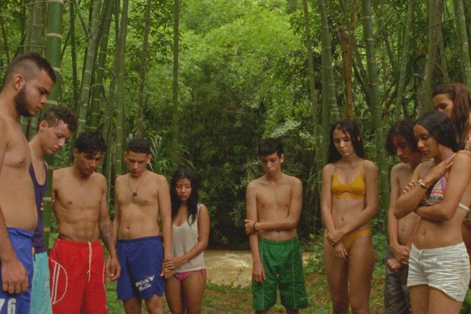 group of young people in swim wear in forest looking at the ground
