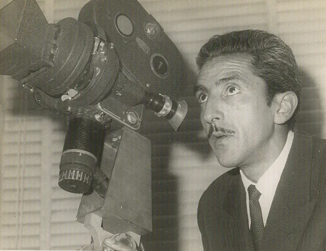 A man holding an old camera