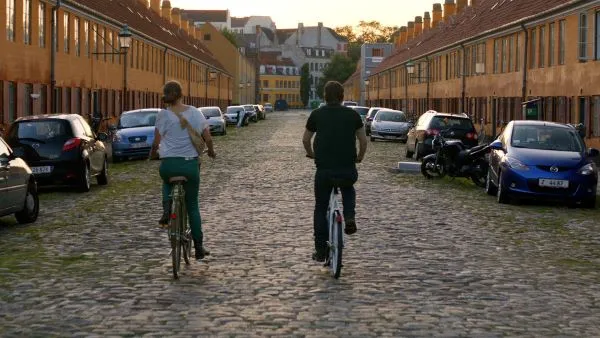 Two people on bicycles in a city 