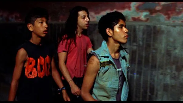 Three young men walking in an alley