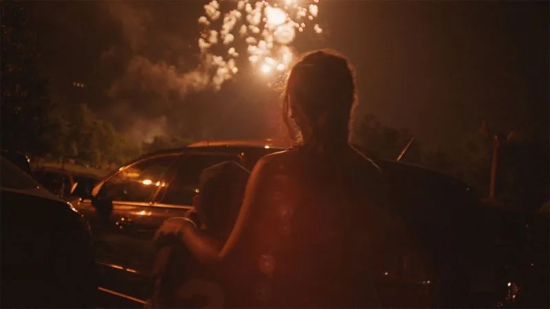 Two figure walking towards a car at dawn