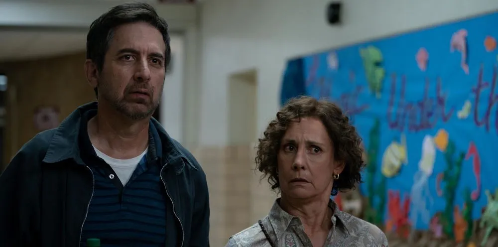 Two adults in a school hallway