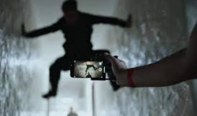 dark silhouette being recorded by a phone