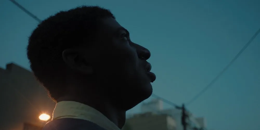 Black man looking at night sky