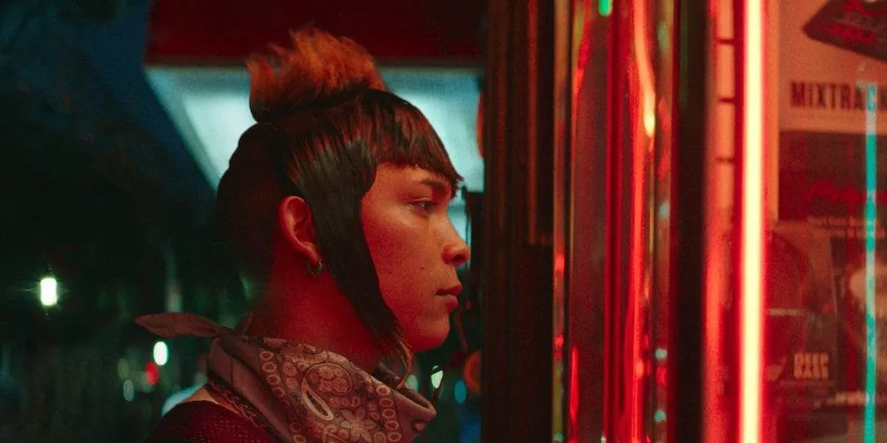 Person staring into neon lit store front