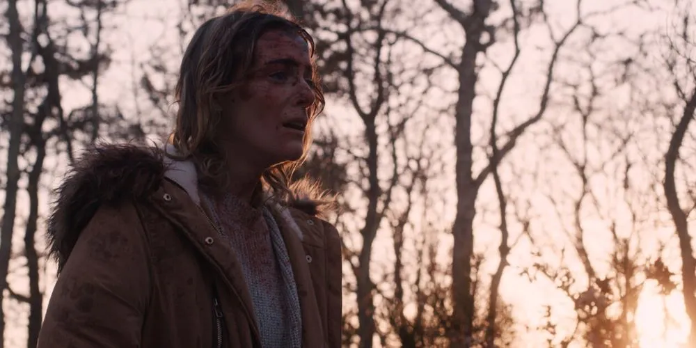 Character in jacket in woods at dawn