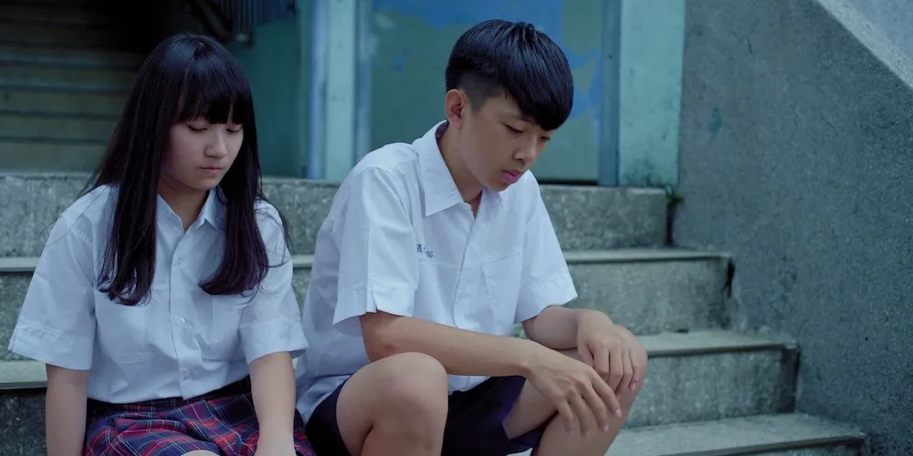 Two young people sitting on a stoop