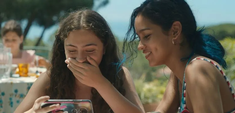 Two girls looking at a cell phone