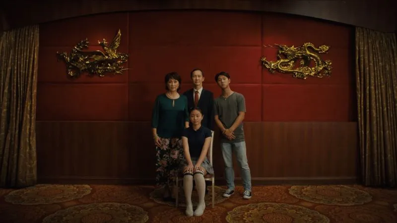 Family portrait in front of red and gold background