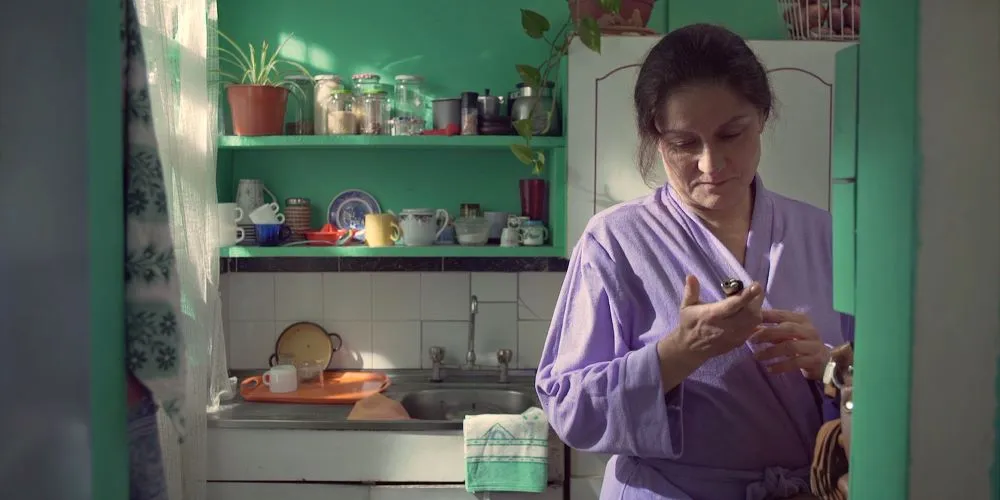 Woman in bathrobe in kitchen