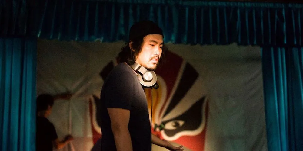 Man with headphones against a theatre proscenium