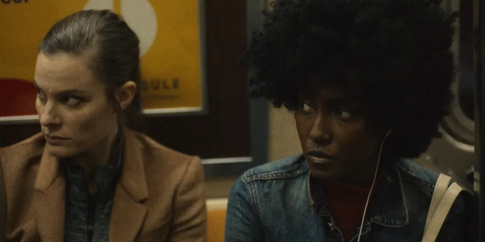 Two woman in a subway car.