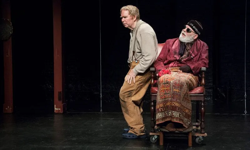 Two older men on stage