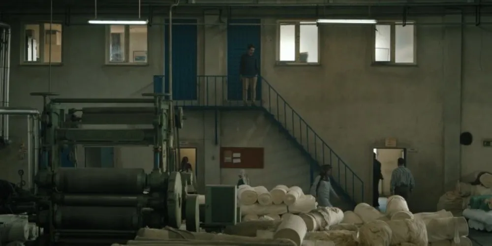 Three people in a warehouse