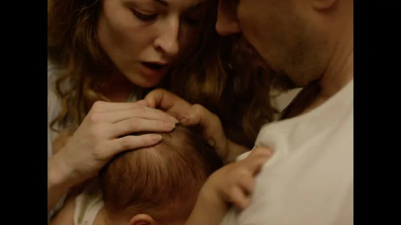 Man and woman holding child