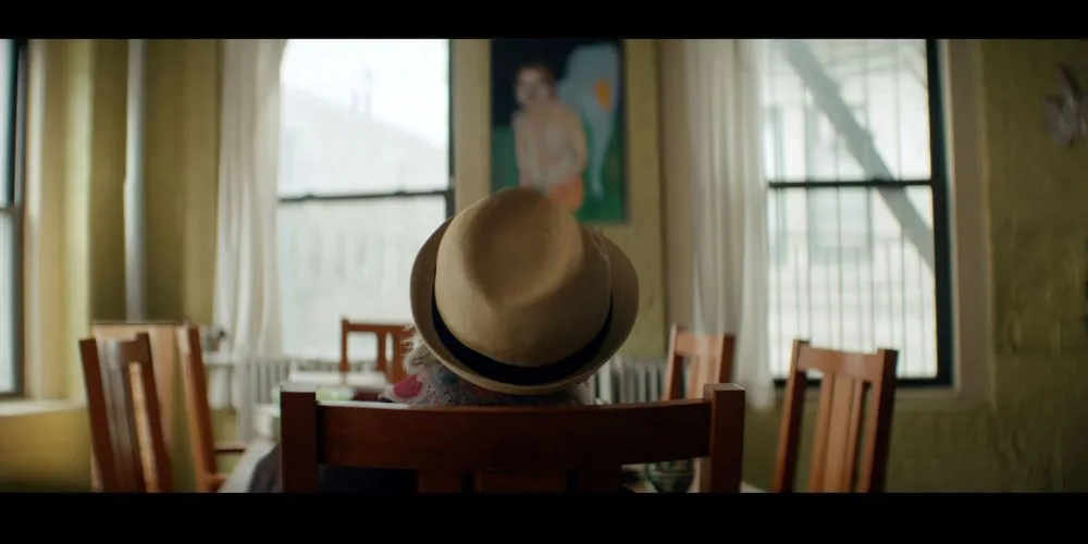 Person wearing hat, seated at dining table