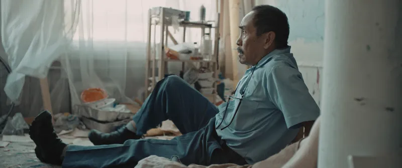 Postal worker seated in construction site