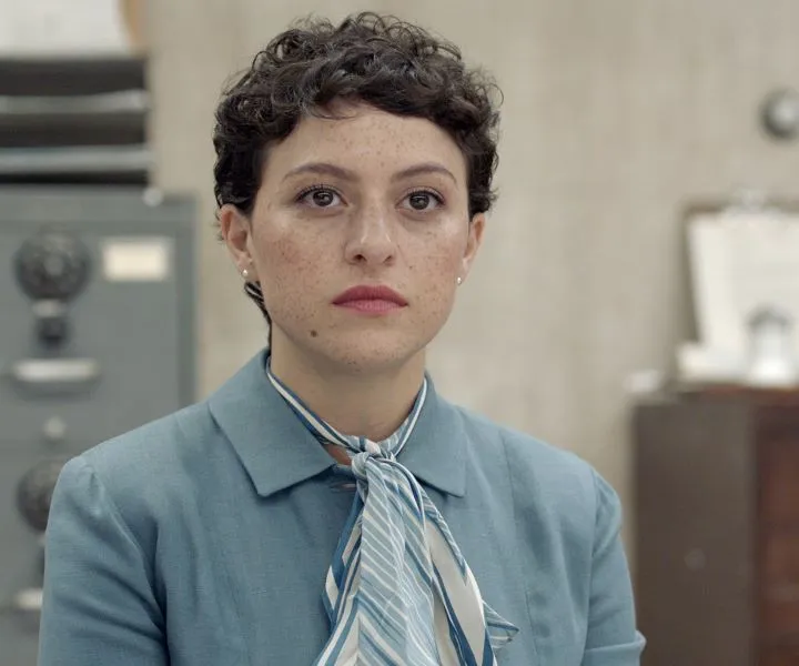 woman with short hair and grey-blue jacket