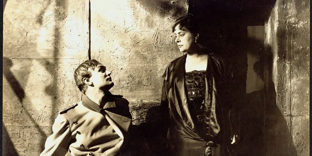 Two costumed individuals photographed in sepia
