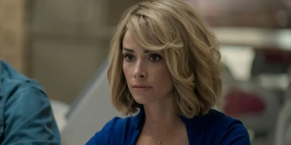 Still from 'Reprsal', a blonde woman with a blue shirt.