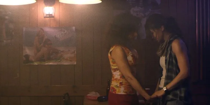 Two people in a wood paneled basement