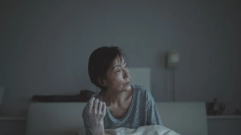 Woman in sparsely decorated interior 